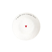 Piatto fondo in grès con scritta nera "in questa casa si mangia bene" e cuoricino rosso al centro.