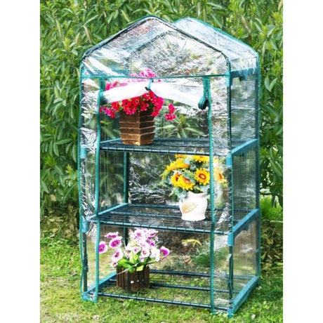 Mini serra con 3 ripiani e copertura trasparente e tnt. Piante visibili, ideali per balconi e terrazzi.