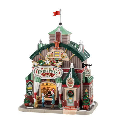 Bottega natalizia di biscotti con personaggi su sfondo bianco.