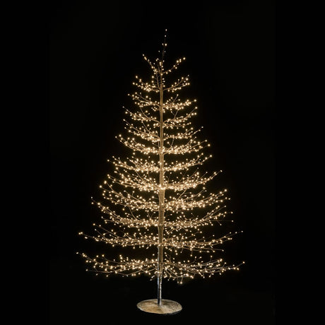 Albero decorativo natalizio alto 210cm con rami sottili illuminato da micro LED bianco caldo su sfondo nero.