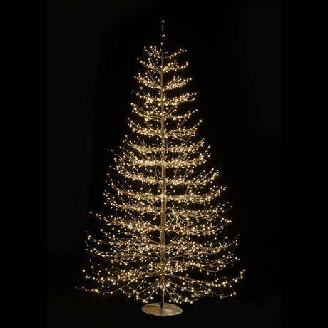 Albero decorativo natalizio alto 240cm con rami sottili illuminato da micro LED bianco caldo su sfondo nero.