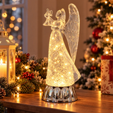 Angelo natalizio luminoso con LED ambientato tra decorazioni di Natale