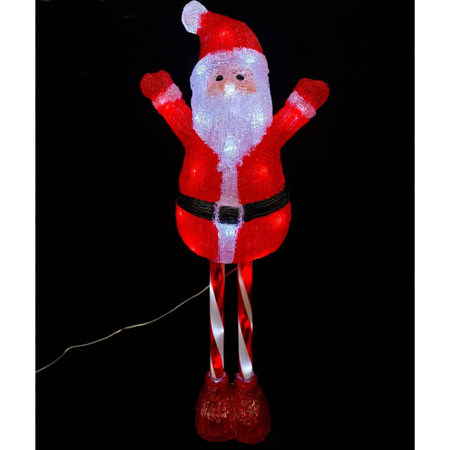 Figura natalizia luminosa raffigurante Babbo Natale con gambe a bastoncino di zucchero, illuminata da LED su sfondo nero.