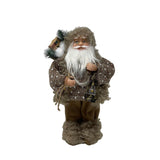 Figura decorativa di Babbo Natale in abiti beige con maglione lavorato, barba bianca, lanterna in mano e sacco con rami e pacchi regalo, alto 30cm. 