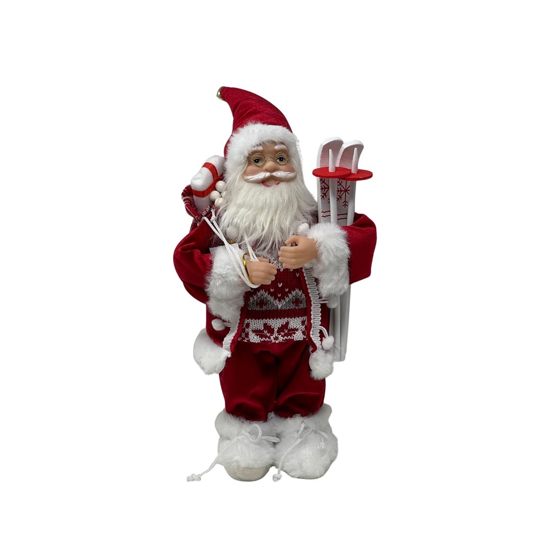 Figura decorativa di Babbo Natale con abito rosso bordato di pelliccia bianca, occhiali dorati, sacco sulle spalle e sci bianchi decorati con fiocchi di neve alto 30cm.