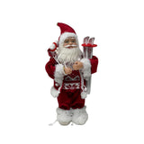 Figura decorativa di Babbo Natale con abito rosso bordato di pelliccia bianca, occhiali dorati, sacco sulle spalle e sci bianchi decorati con fiocchi di neve alto 30cm.