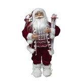 Figura decorativa di Babbo Natale con abito rosso bordato di pelliccia bianca, occhiali dorati, sacco sulle spalle e sci bianchi decorati con fiocchi di neve alto 45cm.