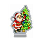 Decorazione luminosa natalizia con Babbo Natale accanto a un albero di Natale verde addobbato con palline colorate