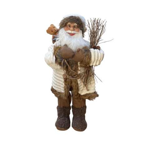 Figura decorativa di Babbo Natale in abiti invernali beige e marroni, con occhiali, barba bianca, sacco con orsacchiotto e fascina di rami in mano, alto 60cm.