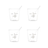 Set di quattro bicchierini in vetro trasparente con scritta bianca in corsivo "un buon caffè" e palettine incluse.