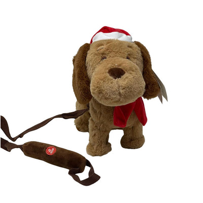 Cane peluche marrone con cappello e sciarpa rossi natalizi, dotato di guinzaglio con comando per musica e movimento.