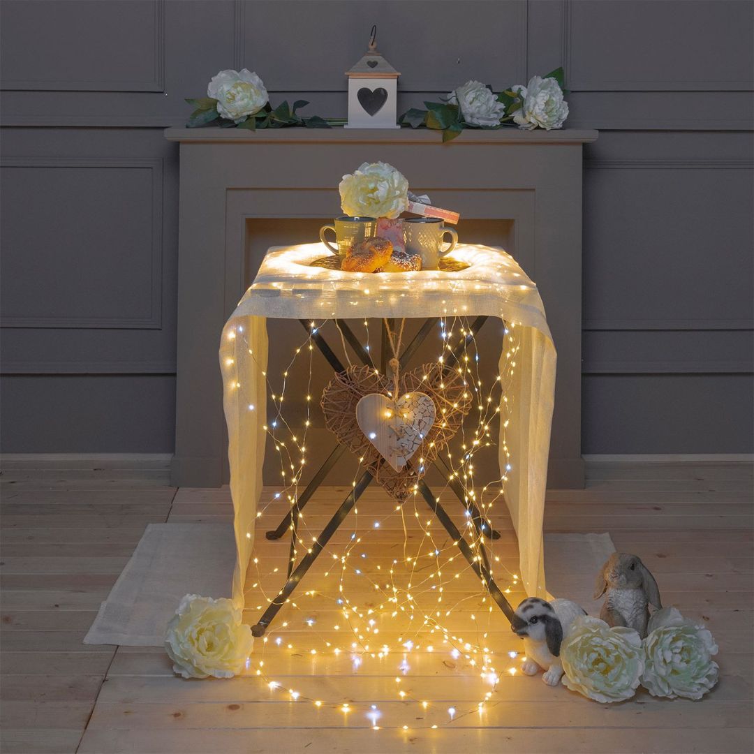 Allestimento interno su tavolo con fili della cascata 900 micro LED bianco caldo e flash LED bianco freddo.