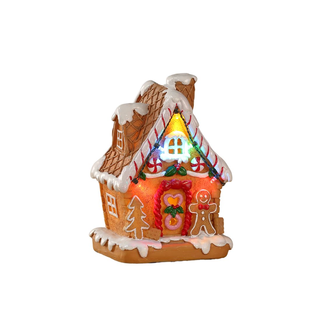 Casetta natalizia in stile pan di zenzero illuminata a LED, decorata con zuccherini, albero e omino gingerbread sulla facciata.