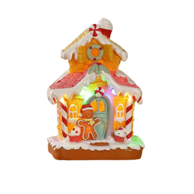 Casetta natalizia in stile gingerbread illuminata a LED, decorata con zuccherini, bastoncini di zucchero e omino pan di zenzero sulla porta.