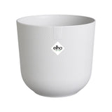 Piccolo coprivaso in plastica riciclata di colore bianco con diametro 7 cm.