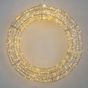 Corona luminosa decorativa a LED di colore bianco caldo, con struttura metallica circolare intrecciata con diametro 38cm su parete grigia.