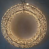 Corona decorativa luminosa con micro LED bianco caldo su struttura metallica circolare diametro 58 cm.