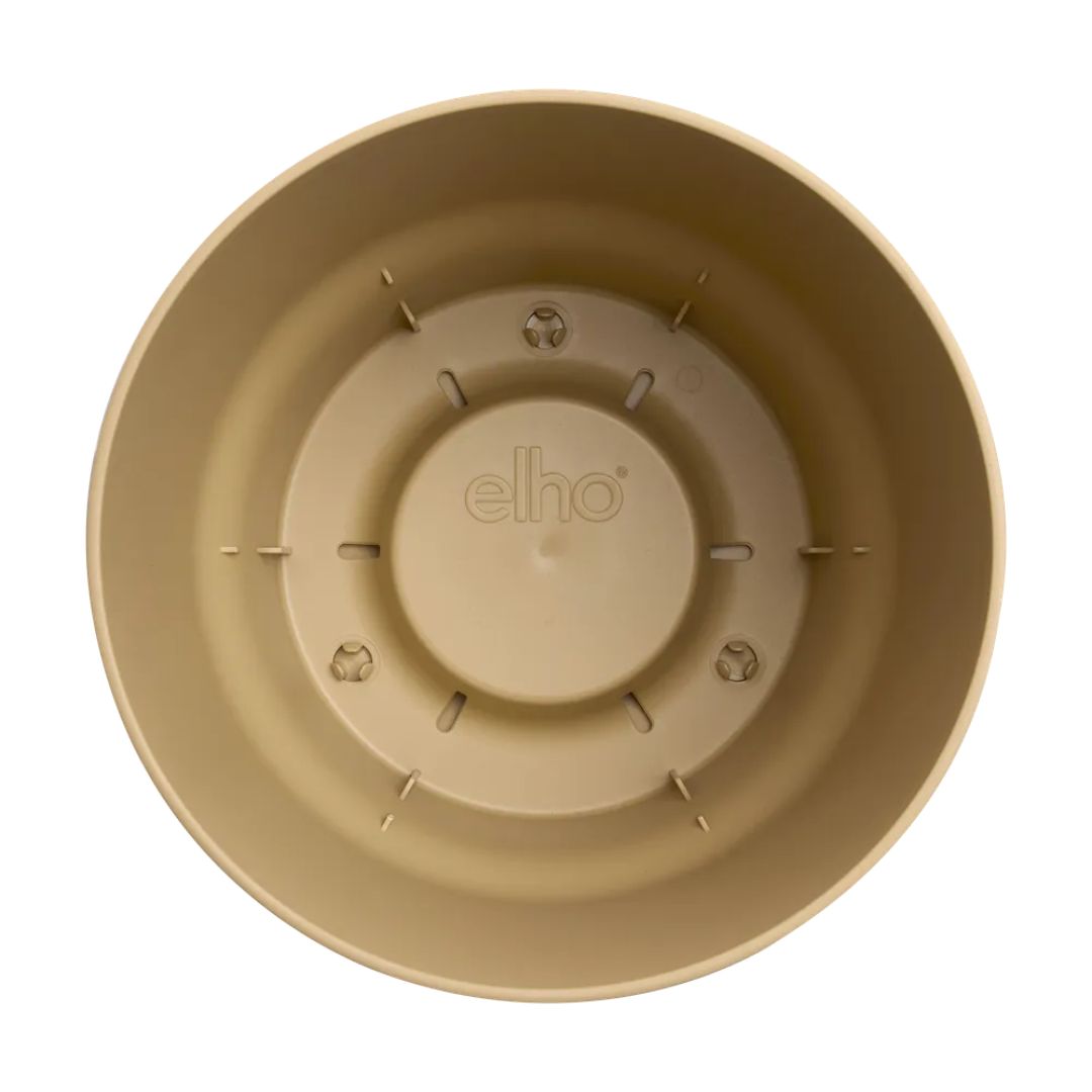Interno vaso rotondo in plastica beige con serbatoio integrato.