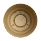 Interno vaso rotondo in plastica beige con serbatoio integrato.