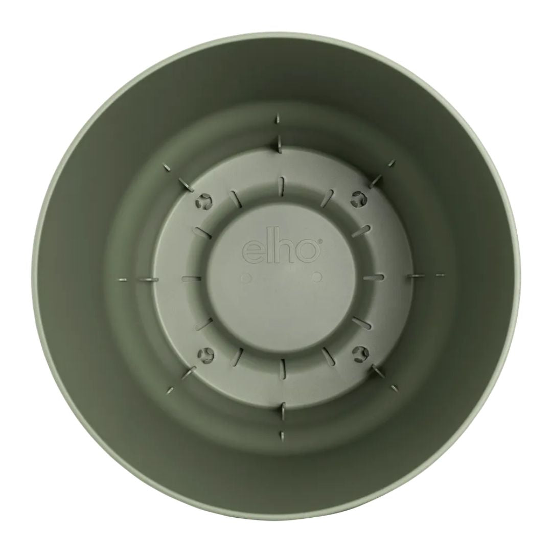 Interno vaso rotondo in plastica verde con serbatoio integrato.