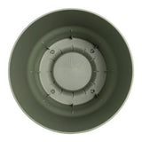 Interno vaso rotondo in plastica verde con serbatoio integrato.