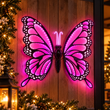 Farfalla LED rosa 60 cm ambientata su parete esterna