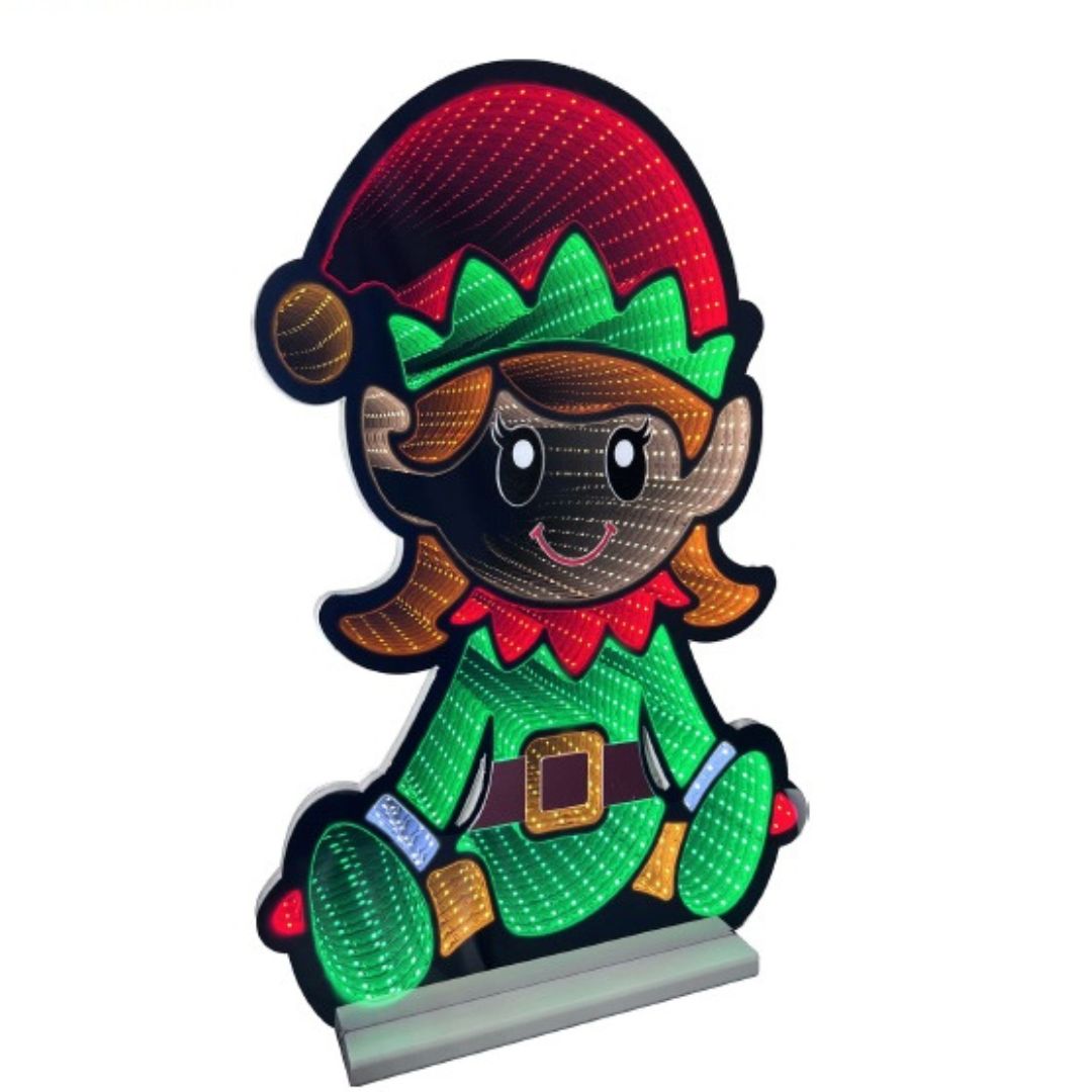 Figura luminosa natalizia a forma di elfa sorridente con cappello rosso e verde, abito verde decorato con LED effetto infinity.
