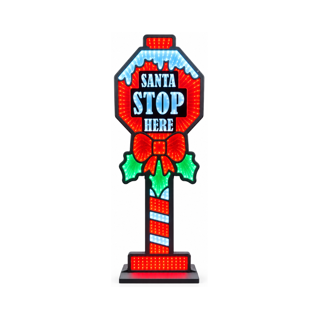 Cartello natalizio luminoso “Santa Stop Here” con luci rosse, bianche e verdi, fiocco e foglie di agrifoglio, su base nera