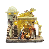 Presepe natalizio illuminato con Sacra Famiglia davanti a una capanna in stile rustico