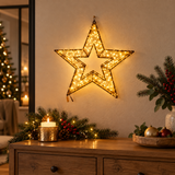 Stella luminosa Garden Team da 38 cm con micro LED bianco caldo, appesa alla parete sopra un mobile decorato per Natale.