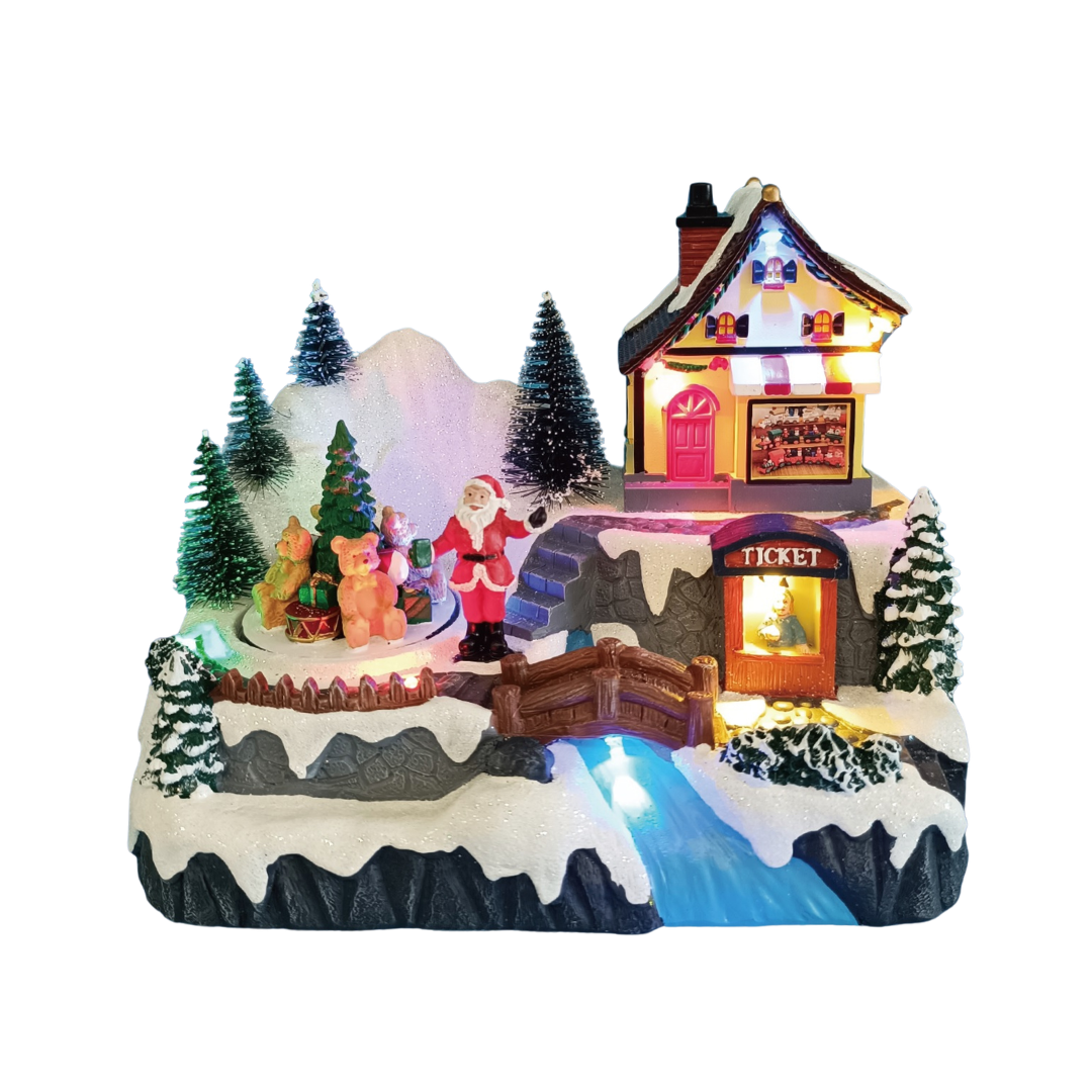Villaggio natalizio innevato illuminato con Babbo Natale, renne, casetta, biglietteria, ponte e ruscello