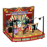 Scena Lemax con palco musicale natalizio, band dal vivo, pubblico che balla e illuminazione decorativa in stile luna park.