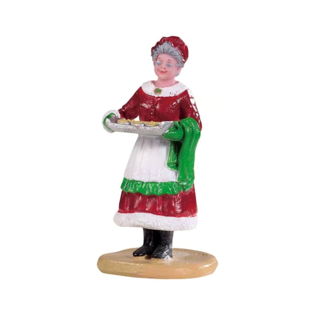 Statuetta della Signora Claus che porta una teglia di biscotti appena sfornati.