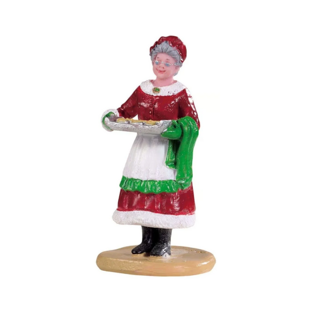 Statuetta della Signora Claus che porta una teglia di biscotti appena sfornati.