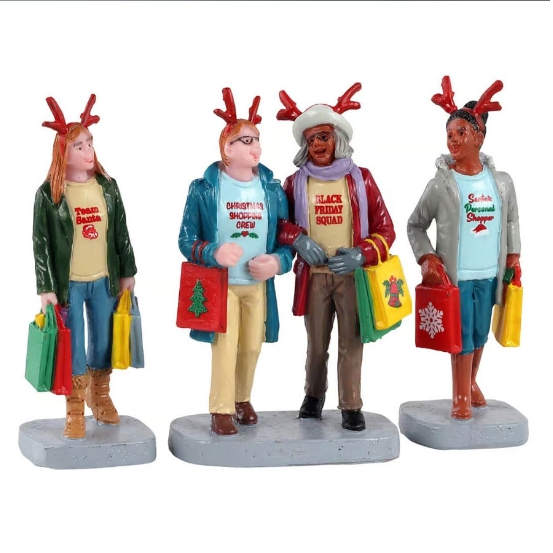 Gruppo di quattro personaggi Lemax con cerchietti da renna e borse colorate, intenti nello shopping natalizio.