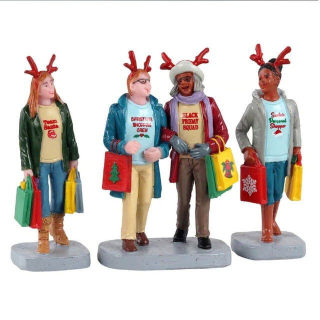 Gruppo di quattro personaggi Lemax con cerchietti da renna e borse colorate, intenti nello shopping natalizio.