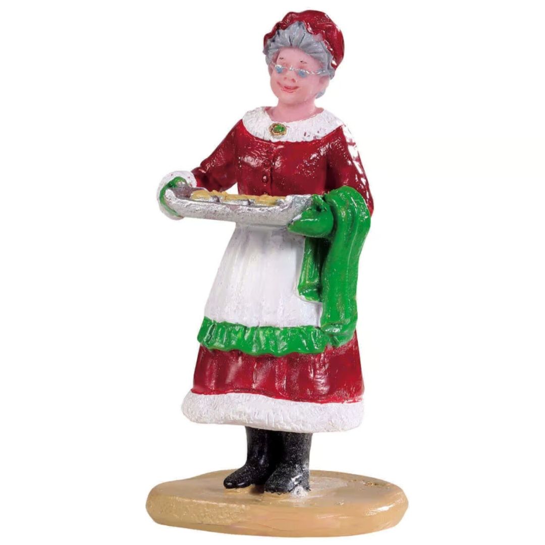 Statuetta della Signora Claus che porta una teglia di biscotti appna sfornati.