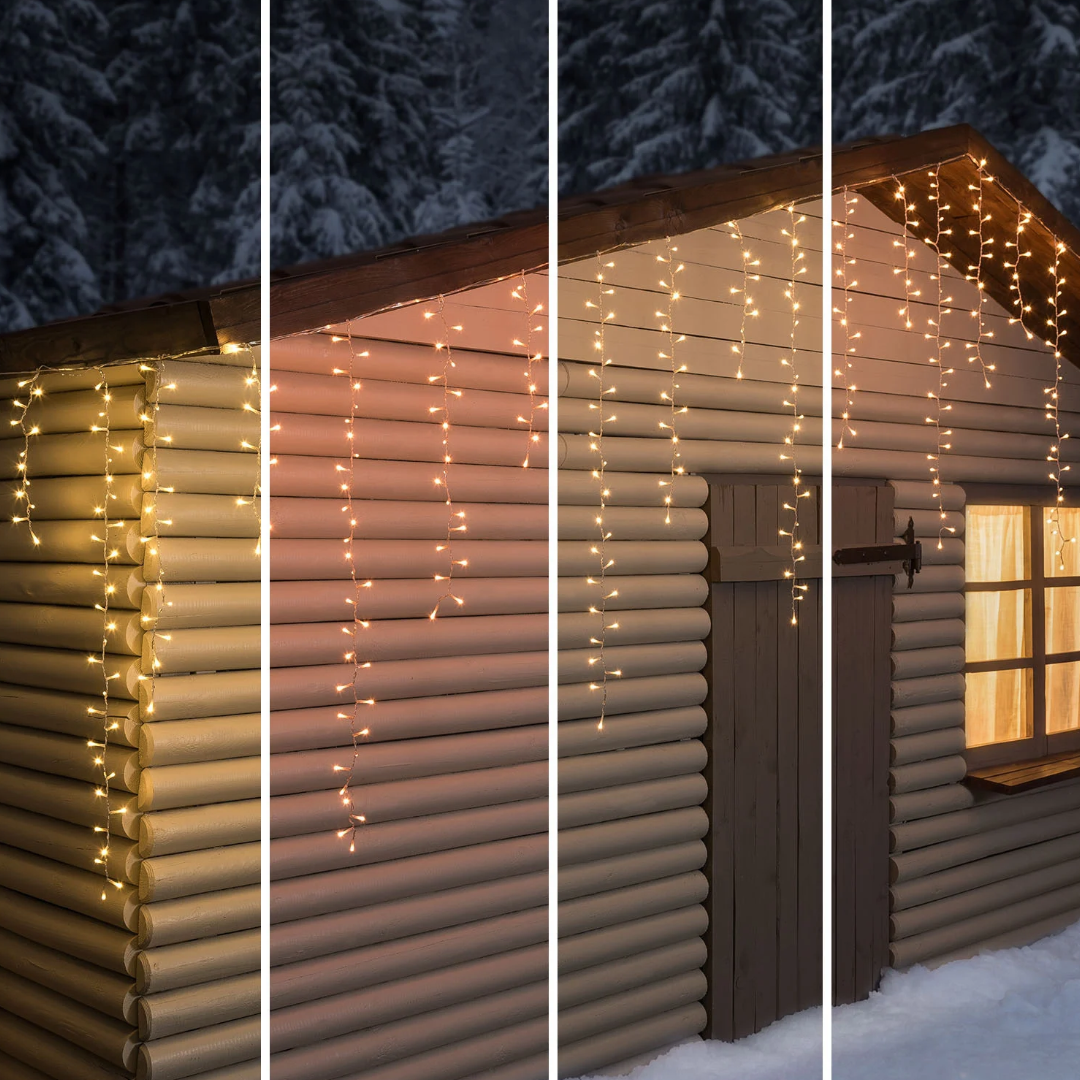 Tenda luminosa Ice Light Lotti installata lungo il tetto di una baita in legno innevata, con quattro tonalità di luce calda.