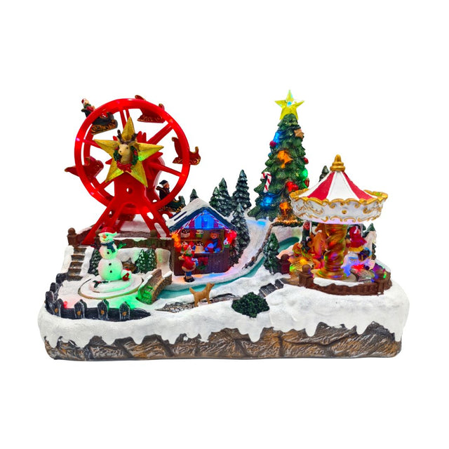 Lunapark natalizio in miniatura con ruota panoramica rossa, albero decorato, giostra illuminata, pupazzo di neve e casetta tra la neve.