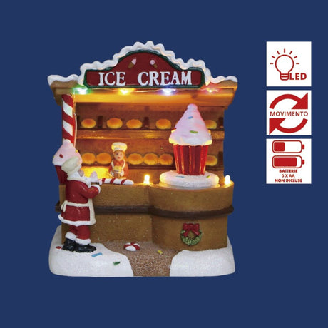 Chiosco natalizio luminosa di gelati decorato a tema, Babbo Natale davanti al bancone e grande cupcake sul lato su sfondo blu