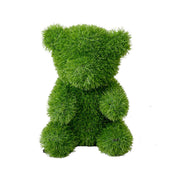 Orso decorativo seduto in prato sintetico verde 20x35cm.