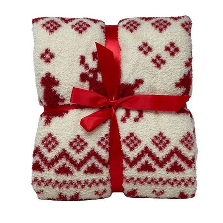 Plaid color bianco con decorazioni rosse a motivi nordici e renne stilizzate, piegato e legato con nastro rosso.