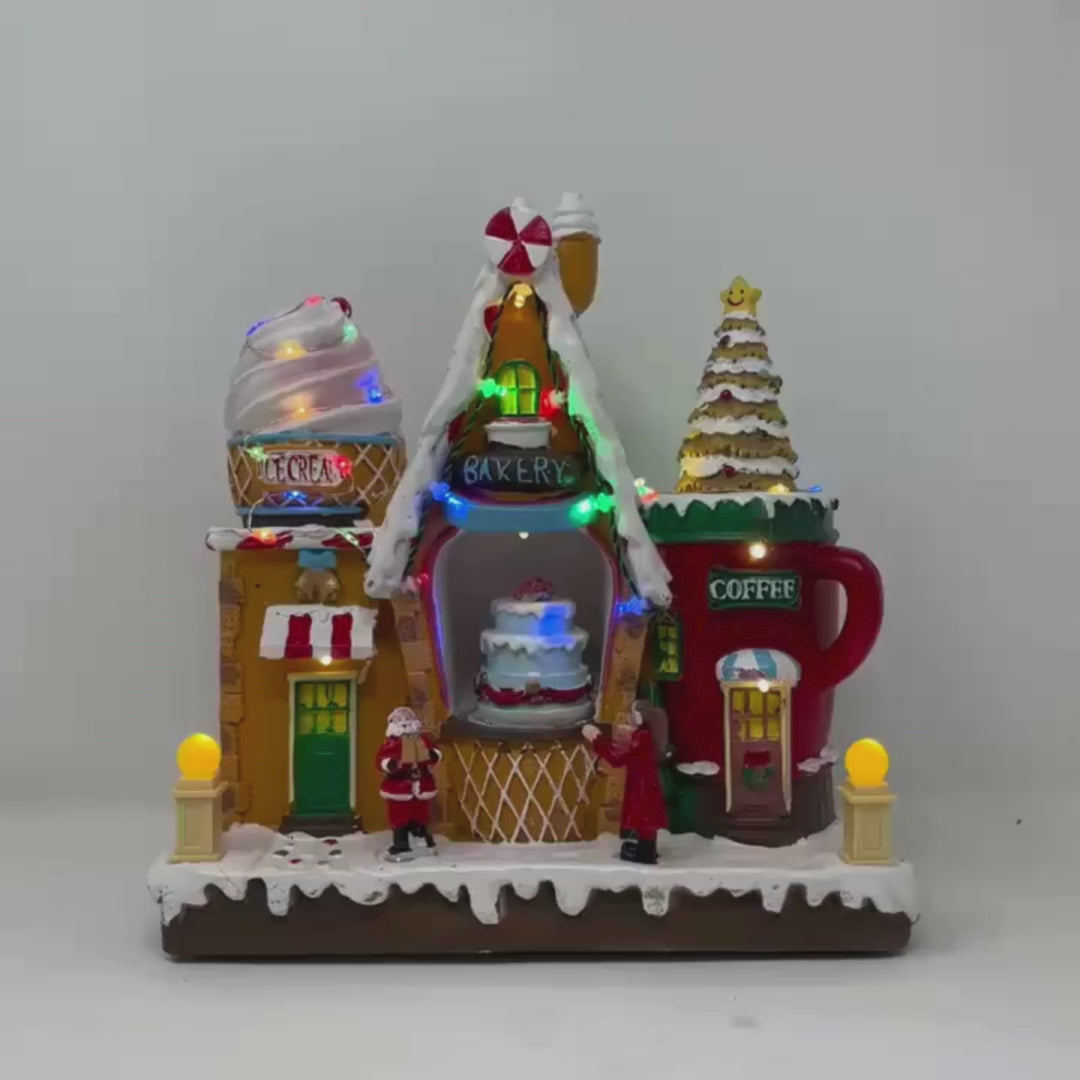 Video del Negozio di dolci natalizio con casette a tema pasticceria, gelateria e caffè, decorato con luci LED multicolore.