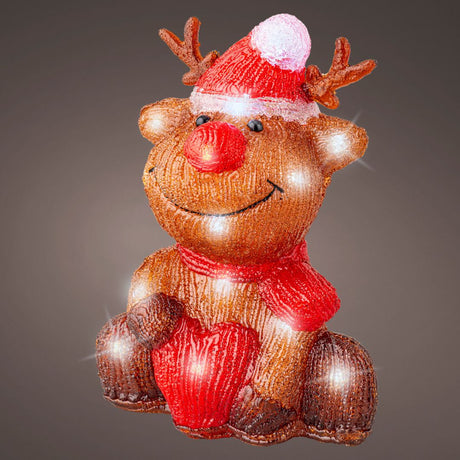 Decorazione natalizia a forma di renna con cappello rosso, sciarpa e cuore, illuminata con LED su fondo scuro.