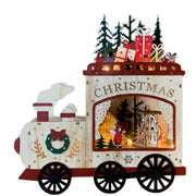 Decorazione natalizia in legno a forma di locomotiva illuminata, con finestra che mostra una scena con casetta, alberi e figure natalizie, e pacchi regalo sulla parte superiore.