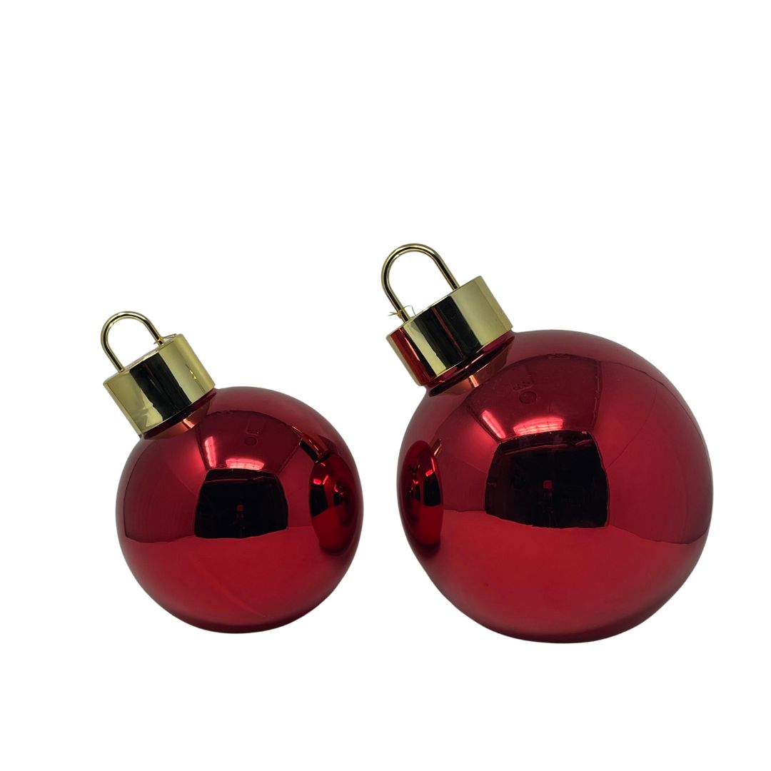 Coppia di sfere decorative color rosso con LED interni e finitura riflettente, in due dimensioni diverse.