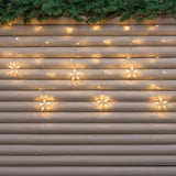 Tenda luminosa con stelle bianco caldo su saracinesca esterna.