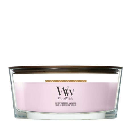 Candela WoodWick Cherry Blossom & Vanilla Ellipse in vaso di vetro con coperchio in legno.