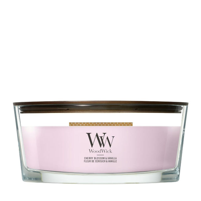 Candela WoodWick Cherry Blossom & Vanilla Ellipse in vaso di vetro con coperchio in legno.