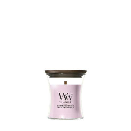 Candela WoodWick Cherry Blossom & Vanilla piccola in vaso di vetro con coperchio in legno.